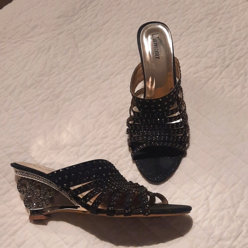 Glitzy shoes with silver colored see through heel and black rhinestones.